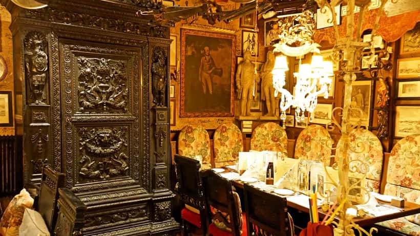 Inneres eines österreichischen Restaurants mit gedeckten Tischen und Holzvertäfelung