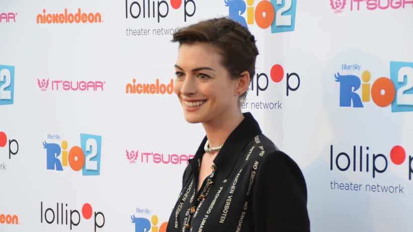 Anne Hathaway at a 2014 public event, smiling in a silver dress