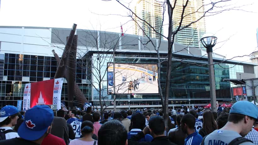 Ice hockey game action inside an NHL arena with fans in the stands during Philadelphia Flyers 2026 playoffs