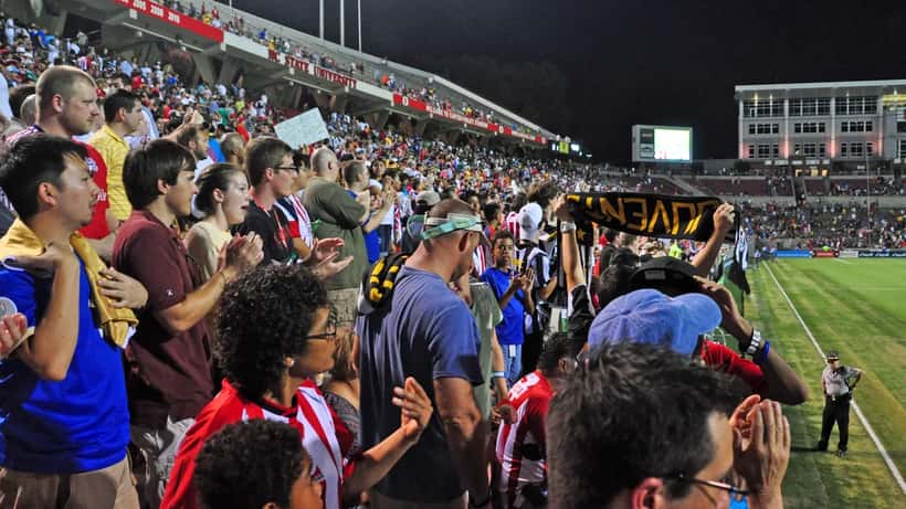 Chivas Guadalajara players competing at a U.S. stadium during an international soccer tournament