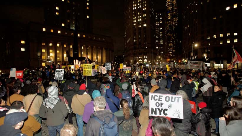Protesters at Foley Square Park holding signs at a rally against the killing of Renee Good, 2026