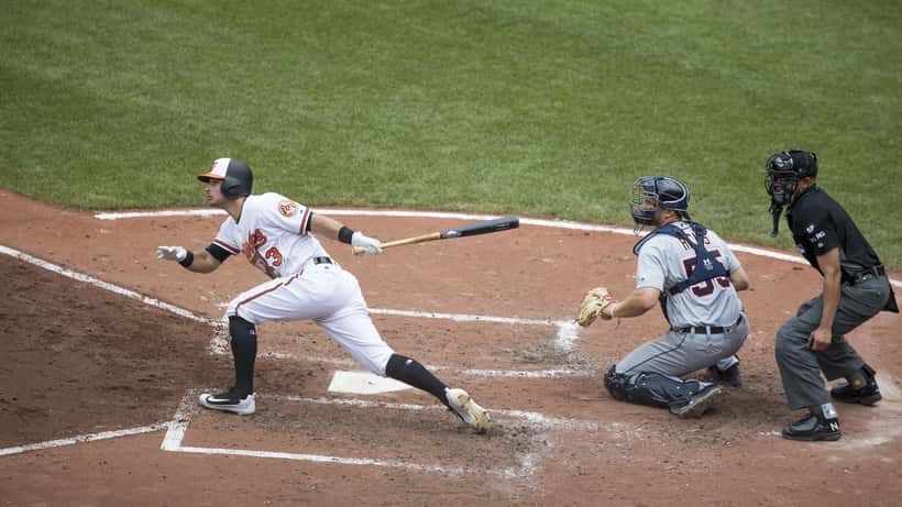 Baseball catcher in full gear crouching at home plate during a game