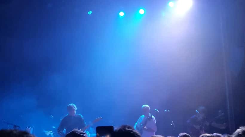 Geordie Greep performing on stage at a concert in 2025