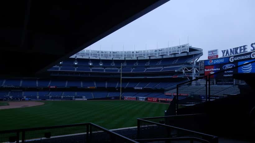 Yankee Stadium exterior on a sunny summer day with fans arriving