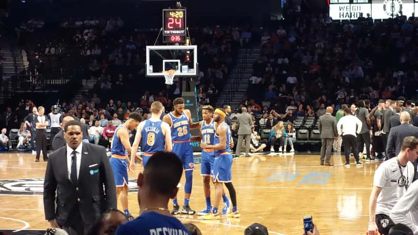 New York Knicks player Mitchell Robinson in game action, whose social media fine raises important workplace conduct questions