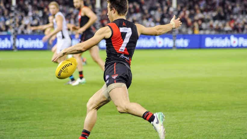 Zach Merrett kicking AFL football for Essendon in 2026