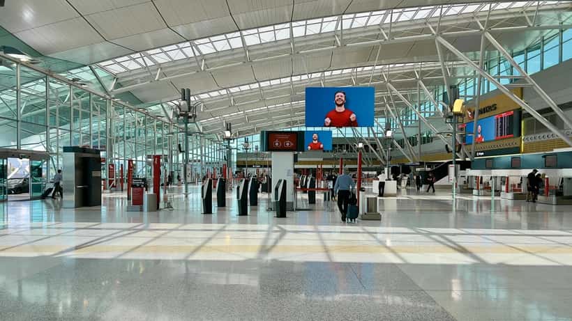 Sydney Airport Terminal 3 interior with passengers and departure gates