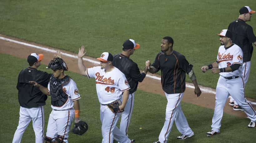 Baltimore Orioles players warming up — illustrating what happens when key team members are suddenly unavailable