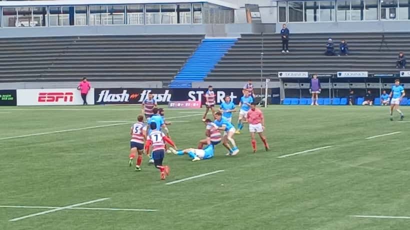 Rugby sevens players in full-speed tackle during international match