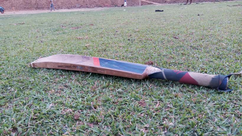 Cricket player executing a powerful batting shot, cricket match in progress