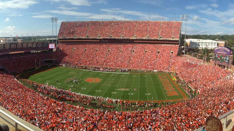 College football game at a packed SEC stadium on a sunny game day