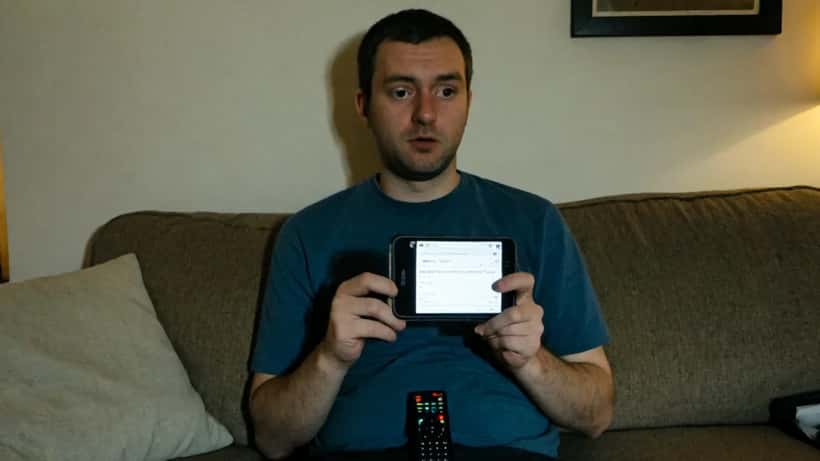 UK consumer reading streaming subscription terms on smartphone at home