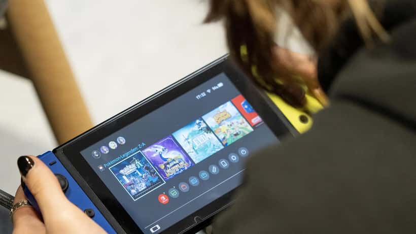 Person playing a Nintendo Switch 2 handheld gaming console