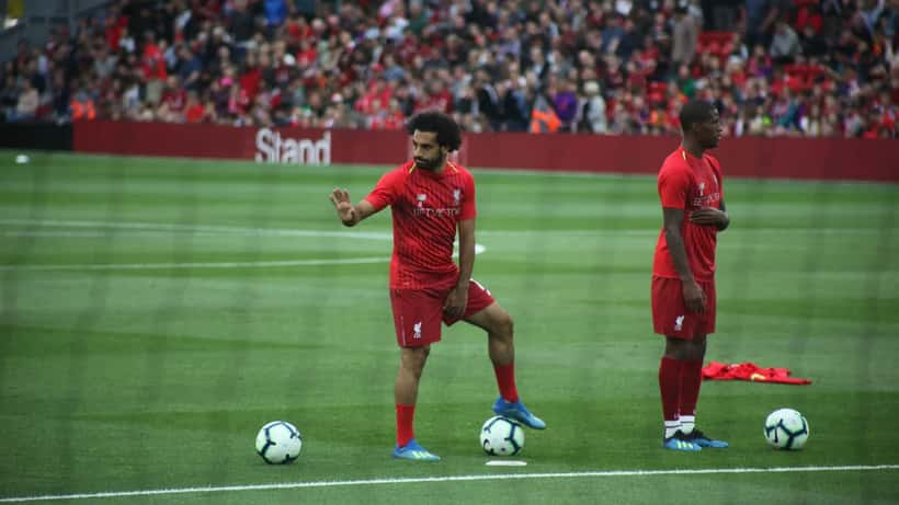 Mohamed Salah in football action wearing his red Liverpool kit