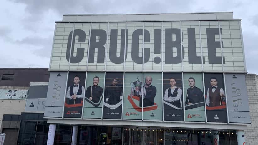 The Crucible Theatre in Sheffield during the 2024 World Snooker Championship with two tables set up under bright lights