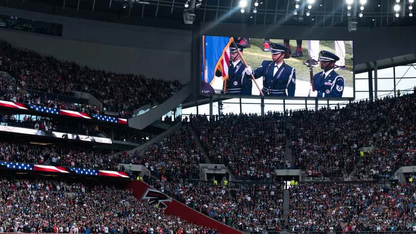 NFL game opening ceremony at Tottenham Hotspur Stadium in London with fans filling the stands