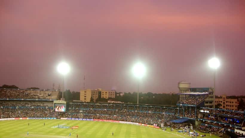Cricket match at IPL stadium in India with large crowd