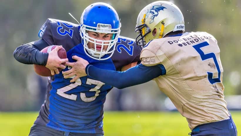 Australian gridiron football players in action on field