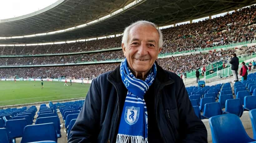 Adepto idoso num estádio de futebol português com cachecol do Belenenses