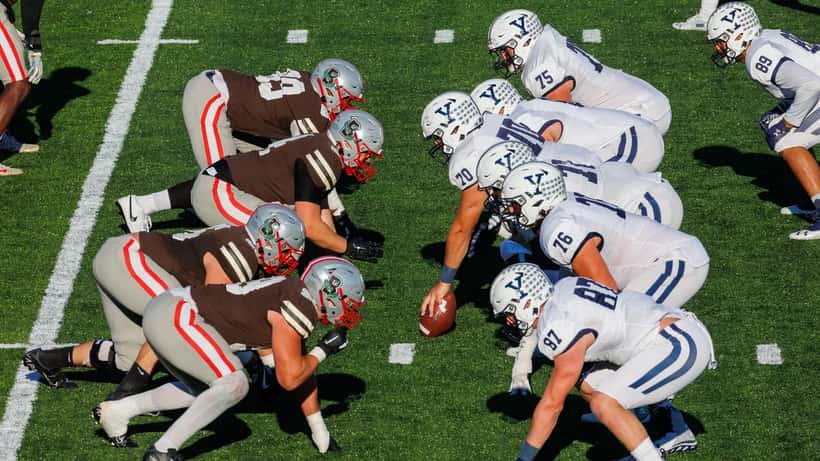 Yale Bulldogs football players in action at Yale Bowl during game against Brown Bears