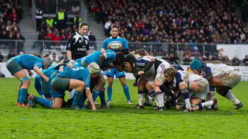 Women's Six Nations rugby players competing in a match, tackle in action
