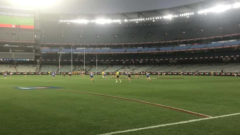 Western Bulldogs AFLW players competing in a match at an Australian football stadium