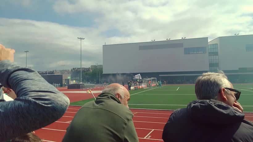 Hibernian fans at Easter Road stadium watching a Scottish football match