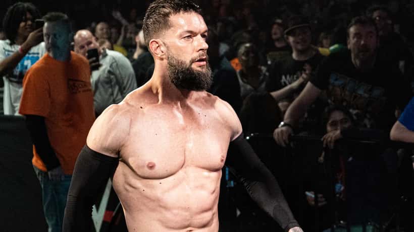 Finn Balor WWE wrestler in ring performing at major event with dramatic lighting