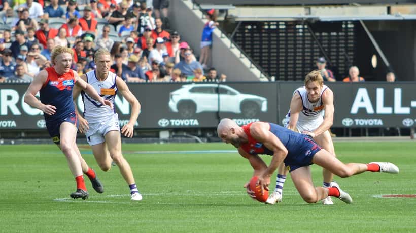 AFL players competing for a loose ball during a match