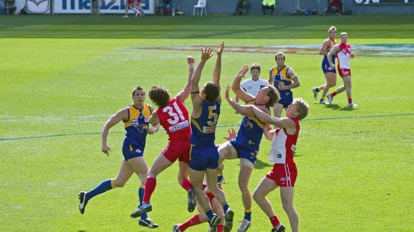 AFL players competing for the mark at the 2005 Grand Final, aerial action shot