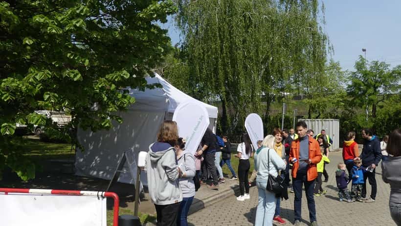 Earth Day 2023 environmental rally with participants gathered outdoors holding signs