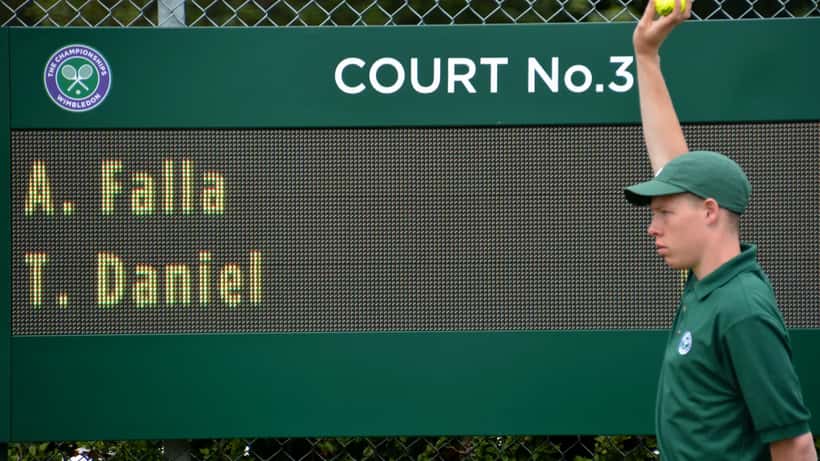 Wimbledon grass tennis courts sign 'It all starts here' at the Championships
