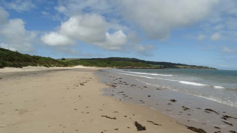 Sunny Anglesey beach on a warm April day showing Traeth yr Ora coastline in north Wales