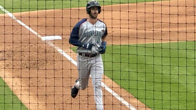 Baseball player sprinting around the bases illustrating the physical demands that cause hamstring and ankle injuries in inside-the-park home runs