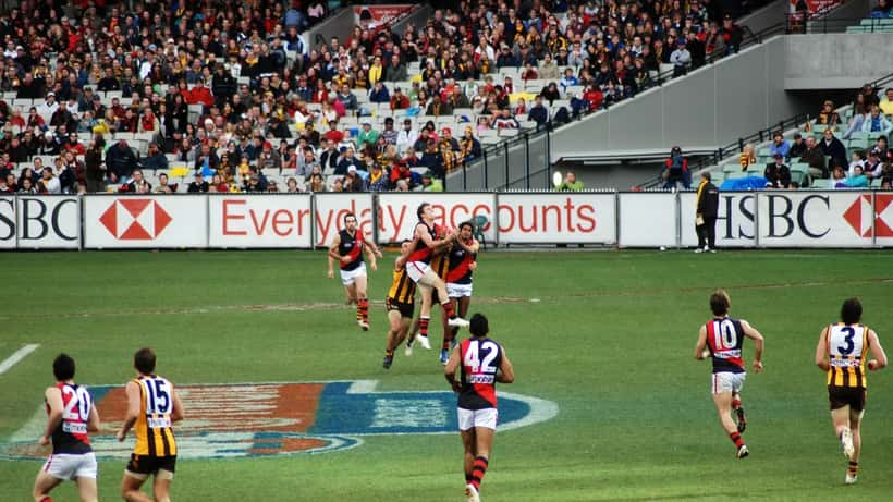 AFL players contest a mark in a Hawthorn versus Essendon game, illustrating the competitive employment landscape of professional football