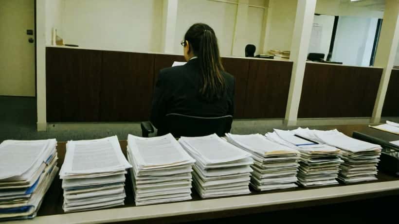 Legal professional reviewing documents at a Melbourne tribunal hearing room