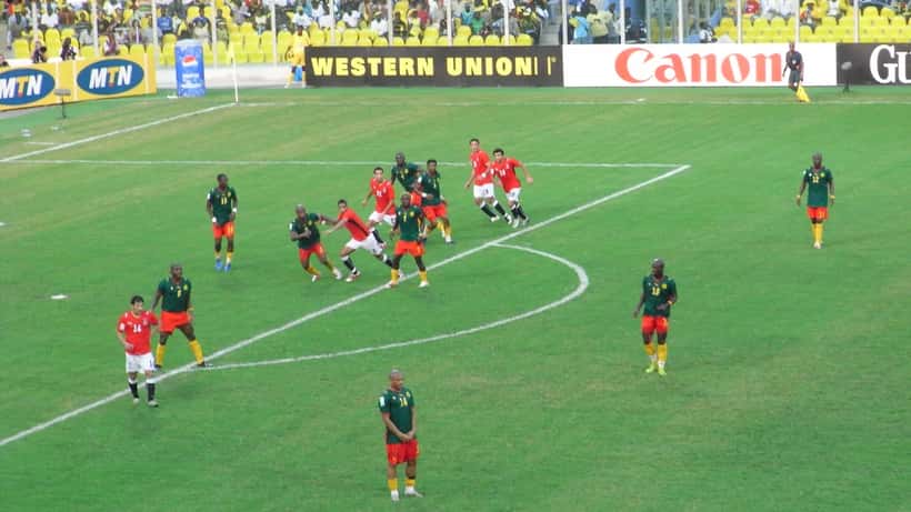 Football players in action at an Africa Cup of Nations qualifier match