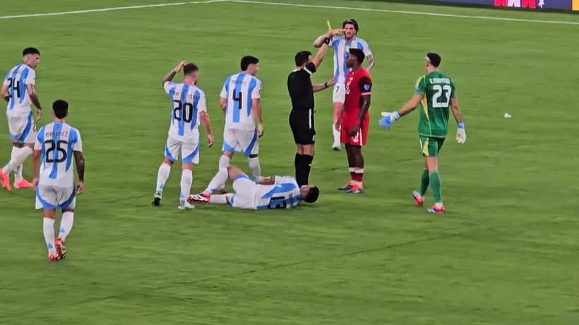 Jonathan David receives a yellow card during Argentina vs Canada at Copa America 2024