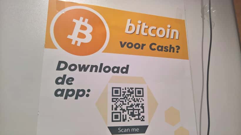 A Bitcoin ATM machine in a retail location, displaying a cryptocurrency exchange interface