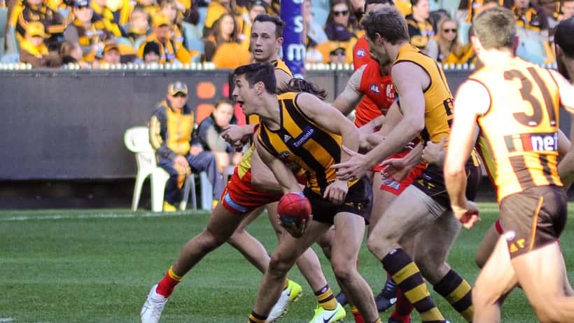 Ben Cousins AFL footballer handball action during a match