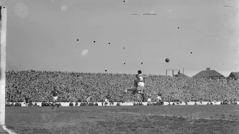 Wales players challenging for the ball in a historic Portugal vs Wales football match