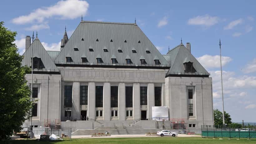 Supreme Court of Canada building in Ottawa, exterior view with Canadian flag