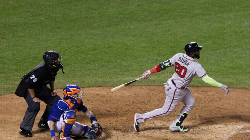 Marcell Ozuna swinging at a pitch in an MLB baseball game