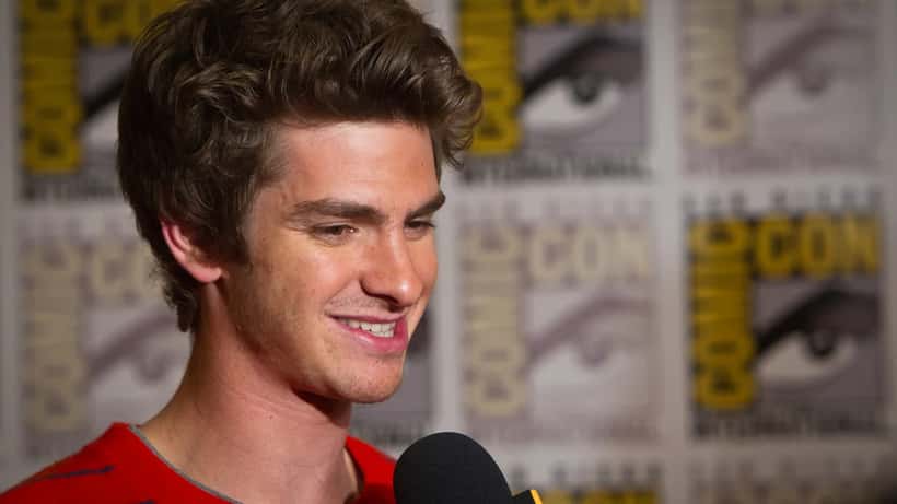 Andrew Garfield at a film premiere wearing a dark suit