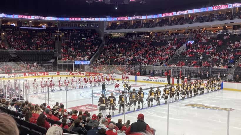 Wisconsin Badgers ice hockey players during pre-game ceremonies at a college arena