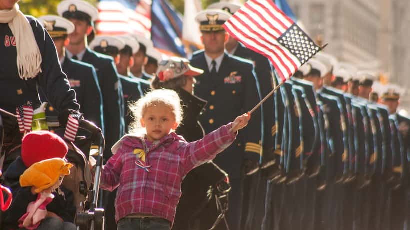 US military families and servicemembers marching representing veterans rights after Operation Epic Fury