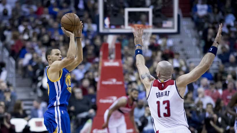 Stephen Curry dribbling on the basketball court during an NBA game for the Golden State Warriors