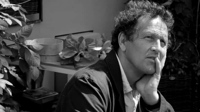 Monty Don at the Hampton Court Flower Show, surrounded by summer blooms, speaking with gardening enthusiasts