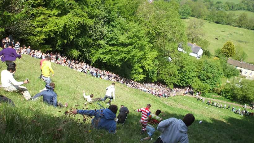 Competitors tumbling down Cooper's Hill during the Gloucestershire Cheese Rolling event