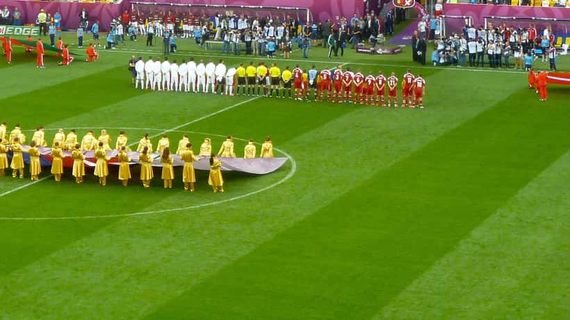 Jogadores de Portugal e Dinamarca durante os hinos nacionais numa partida UEFA